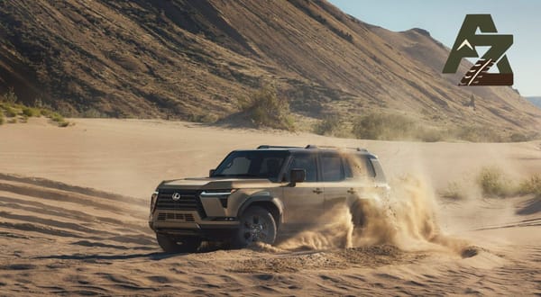 2024 Lexus GX550 driving off-road over rocky terrain, showing its squared design and adventure-ready stance.